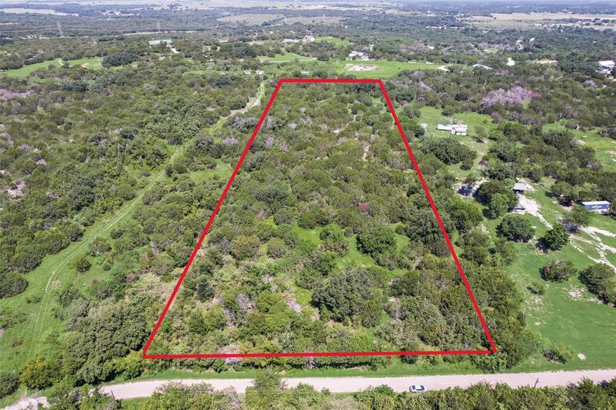 Looking for a bit of land that's close to both town and a lake? Look no further! This 5.7-acre parcel of undeveloped land is fully fenced and includes a loafing shed for your livestock. Located just 7 miles west of downtown Granbury, this heavily treed property sits on a peaceful dead-end road, offering privacy and tranquility. While the land has remained untouched for decades and does not have a drivable entrance, it holds great potential for new beginnings. There was once a water well approximately 80-100 feet deep, though the pump has been removed. Please note that minerals are excluded. This land is ready for its next chapter with a new owner!