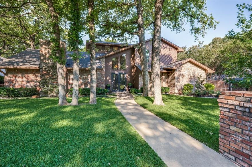 Nestled in Woodhaven Country Club Estates, this beautifully landscaped home offers mature trees and outstanding curb appeal. Featuring three bedrooms and two baths, the home boasts two spacious living areas, one with a wood burning fireplace and the other with a wet bar along with a snooker table. The downstairs primary suite offers a walk-in closet, double vanity, tub, and separate shower. The kitchen features granite countertops, newer appliances, an eat-in breakfast area, and a separate formal dining room. Upstairs are two bedrooms connected by a Jack-and-Jill bath. Located just blocks from the International Leadership Academy, with Nolan High School option also available for your high schoolers. No HOA. Additional features include a rear-entry garage, landscaped backyard, open patio area perfect for entertaining and an electric wrought iron gate. Conveniently located just 10 minutes from downtown Fort Worth and Sundance Square. No Survey.