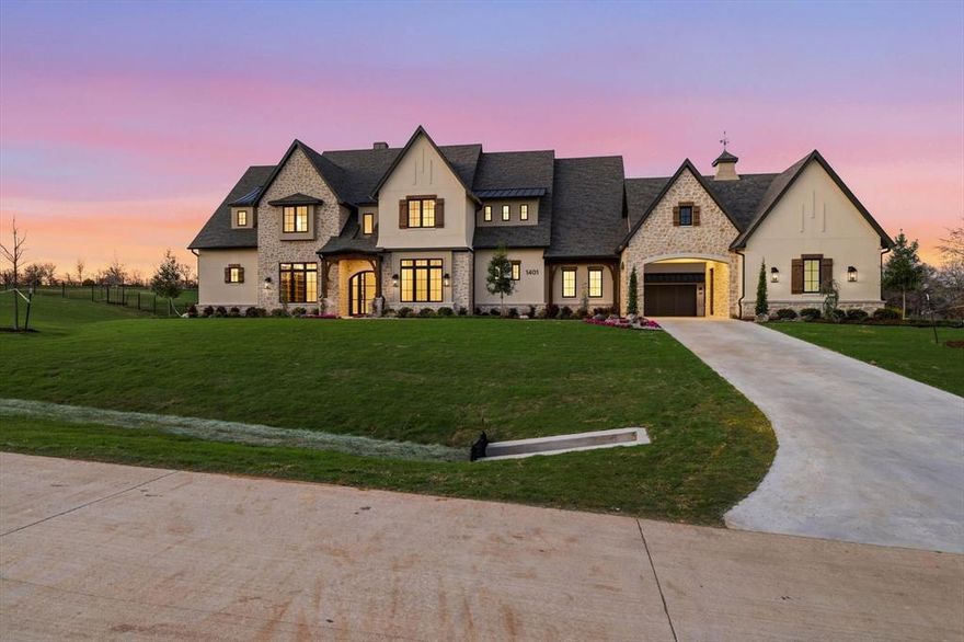 Set on 2 acres at 1401 Brian Street, this stunning Denton Creek Custom Home delivers the kind of skyline views and rolling terrain that are hard to find anywhere else in the area. Positioned on a south facing corner lot near the entrance, this home makes an immediate impression with beautiful curb appeal, timeless stonework, and a layout built for both everyday living and entertaining.

Inside, the open living space is filled with natural light and anchored by soaring vaulted ceilings, striking wood beams, a dramatic stone fireplace, and oversized western sliding doors that open seamlessly to the outdoor living area. The kitchen is a true showpiece with a Le Cornue range, oversized island, custom cabinetry, and a separate prep kitchen that keeps everything organized and out of sight when hosting.

With 6189 square feet, this home offers 5 spacious bedrooms, 5 full baths, and 3 half baths. The private study gives you a quiet space to work from home, while the game room with bar is ready for movie nights, game days, or casual get togethers. The primary suite feels like a luxury retreat with a spa inspired bath, freestanding tub, dual vanities, and a bright elegant finish.

Step outside to enjoy the covered patio with retractable screens, outdoor grill, and fireplace, creating a year round space to relax and entertain. A balcony adds even more opportunity to take in the views. The 4 car garage with porte cochere provides plenty of room for vehicles and guests.

Zoned to Denton ISD, this one blends luxury, comfort, and a setting that truly stands out.