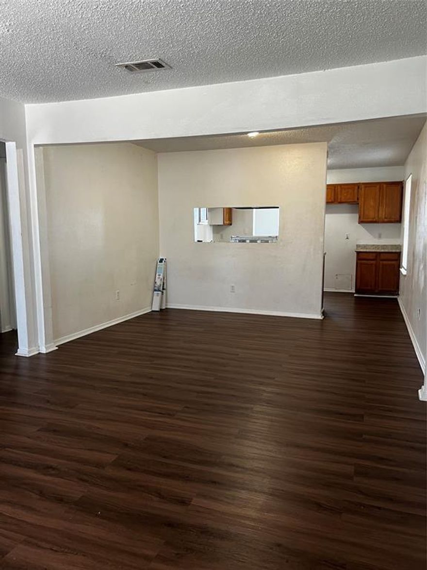 Step into this must-see 2-bedroom, 2-bathroom apartment, located on the 2nd floor of a charming four-plex. An expansive open floor plan greets you, connecting the living and dining rooms to create an ideal space for entertaining or relaxing. Rich laminate wood flooring graces the kitchen, laundry connection area, and both full bathrooms. The kitchen also features a practical pass-through window. Retreat to the master bedroom, capable of accommodating a queen or full-size bed, and benefit from the generous walk-in closet. The second bedroom is also well-proportioned and includes a large closet, offering flexibility for various needs.