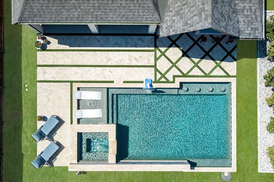 Stunning Prosper home on quarter acre corner lot with pool, spa and outdoor kitchen! Pool equipped with tanning ledge, built in stools, waterfalls, in floor cleaning system and can be heated or chilled. Gorgeous travertine decking in herringbone pattern with turf inlay; outdoor speakers; ledge lounger chairs included. Amazing outdoor kitchen extends roofline with custom tv enclosure, lighting and fan, bartop, grill, flattop, pizza oven, built in barstools and storage. This 4 bed, 3.5 bath beauty features a media room, dog room, oversized laundry with quartz waterfall counter and upper cabinets; 3 car tandem garage with epoxy floors. Totally remodeled, shows like a model with wide plank white oak wood floors, power shades, plantation shutters, custom bar with wine fridge, accent walls, custom vent hood, quartz counters, upgraded lighting and fixtures, smart home features, extensive landscaping and more. Great community with trails, park, pool. Walnut Grove HS, faces SW. NO MUD OR PID!