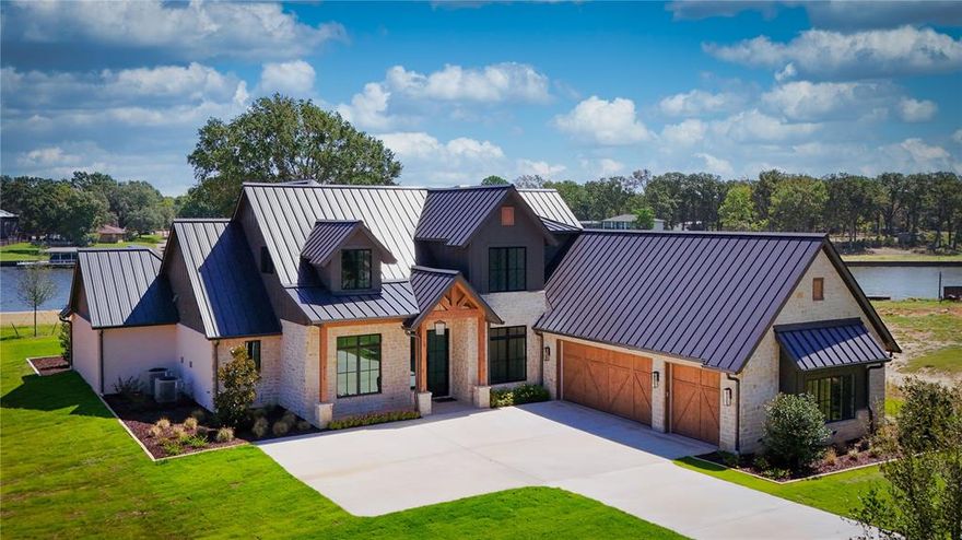 Exquisite model home with 1000 + sq ft composite boat house now complete! The Groves at Cedar Creek Lake is a new 23 acre luxury gated waterfront community with deep water, fabulous water views and gorgeous sunrises. Built on one of the premier lots with cove protection, open water views and approx. 177 ft of waterfront at the wall. The finish out of this home is absolutely stunning and selected with ease of maintenance and durability in mind. Bonus room plus game room and built in bunk room! Lifetime warranty white oak engineered wood floor, Vadara quartz honed counter tops, custom cabinetry, Jenn Air appliances, and more. The spacious covered patio with outdoor kitchen, fireplace and heaters offer year round outdoor living. Plenty of room for a pool. Includes grass, landscaping, sprinkler system. Second home under construction with estimated completion September 2024. Lots available starting at 525K and more homes available starting at 1.8 million. New photos and website coming soon!