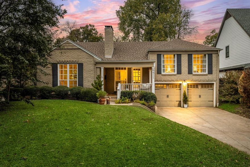 Situated on an oversized 55x157, tree-filled lot on one of Lakewood’s most coveted streets, this charming cottage presents a rare opportunity within the highly sought-after Lakewood Elementary attendance zone. Surrounded by mature trees and beautiful homes, the property offers both a move-in ready residence and exceptional potential for a future custom build in one of East Dallas’ most desirable neighborhoods.
A welcoming front porch introduces light-filled interiors where hardwood floors and an ornate fireplace anchor the inviting living room. The dining room features classic built-in cabinetry and flows seamlessly into the updated kitchen, appointed with Carrera marble countertops, stainless steel appliances, and custom lighting—creating a warm and functional space for everyday living and entertaining.
The home’s thoughtfully designed split-level layout provides both charm and flexibility. The main level features the living room, dining room, kitchen, a secondary bedroom with its own fireplace, and a full bathroom. Just a few steps up are two additional bedrooms and a second full bath. A few steps down from the main level leads to the lower level with an oversized utility room offering abundant storage and access to the attached two-car garage.
Outdoors, the expansive backyard is framed by mature trees and offers a wonderful space for relaxing or entertaining, complete with a patio, stone firepit, and built-in gas grill. The generous lot size presents an exceptional opportunity to enjoy the home today while also offering the flexibility to build in the future.
Properties offering this combination of lot size, location, and Lakewood Elementary zoning are increasingly rare. Whether you envision preserving the charm of this classic Lakewood cottage or creating a custom dream home, 6411 Bob O Link presents a truly special opportunity in the heart of Lakewood.