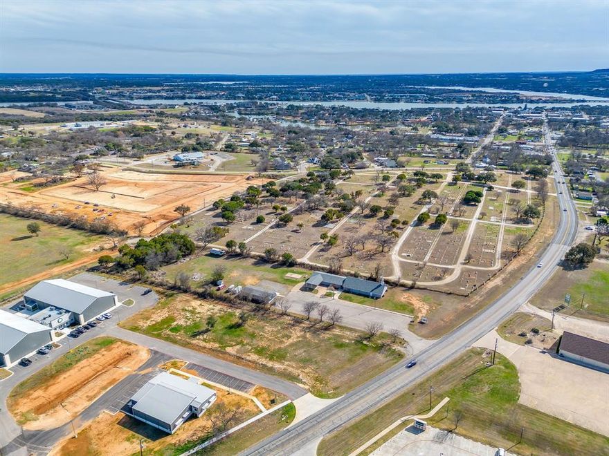 Zoned Heavy Commercial - This lot fronts on the Weatherford Hwy (Houston Street) with existing entrance on Tucker Way.  Common area maintenance agreement for Lots 1-4. City water, co-op electric, septic available, sewer close by. Excellent commercial location just north of Granbury Square.