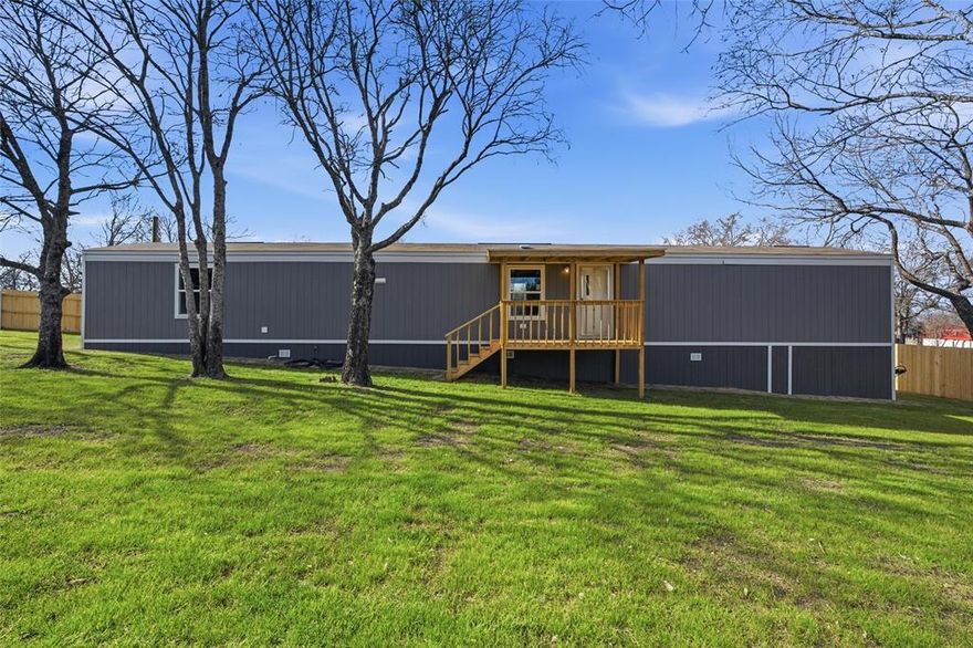 Welcome to this brand new 3 bedroom,2 bath cutie tucked away in a quiet small town setting where life feels a little slower and a lot sweeter. Situated on a fully fenced lot with large, mature trees, this home offers the perfect blend of new construction comfort and established charm. Inside, you will find a fresh, functional layout designed for easy living, featuring bright, open spaces and cozy bedrooms. With everything brand new from top to bottom, all that is left to do is move in and enjoy. Whether you are sipping your morning coffee under the trees, letting pets roam freely, or hosting low key get togethers, this home makes everyday moments feel special. Affordable, adorable, and ready for its first owner, this is small town living done right.