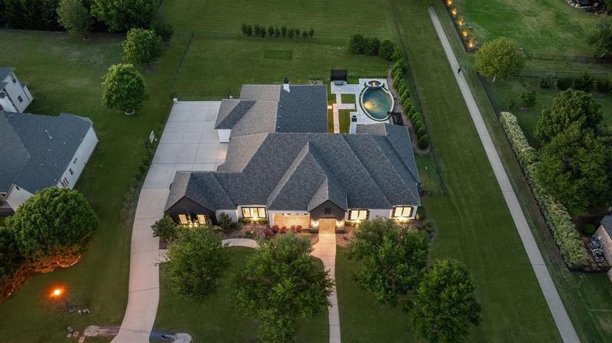 Tucked away on a private cul-de-sac lot spanning nearly an acre, this breathtaking Dave Williams home in the prestigious Whispering Farms community underwent a complete luxury transformation in 2022. Blending sophistication, and comfort, this exquisite residence offers a rare opportunity to own a thoughtfully reimagined home in a prime location.
Step inside to soaring ceilings that highlight the home’s open, airy layout. The gourmet kitchen is a true showstopper—featuring a massive island and an open floor plan that flows effortlessly into the spacious family room, where large doors invite you out to the stunning backyard. A dedicated office offers flexibility and can easily be converted into a fifth bedroom. The expansive game room opens directly to the resort-style outdoor space, perfect for seamless entertaining, while a newly added private media room offers an exclusive retreat.
The luxurious primary suite is a sanctuary all its own, featuring designer lighting, a cozy fireplace, and direct access to the outdoor haven. A California Closets-designed walk-in closet adds custom organization to this elegant space.
Every inch of this home has been updated with style and function in mind. In 2022, all bathrooms were fully remodeled, plush new carpet was installed, a whole-home water softening system was added, and motorized sunshades were incorporated for added comfort. The backyard was transformed with new turf, improved drainage, and a cozy fire pit—creating the ultimate space for relaxation.
Significant system upgrades include two Trane HVAC systems, enhanced insulation, and a new half bath added to the upstairs media room. In 2024, a brand-new roof and modern garage doors were installed, ensuring lasting durability and striking curb appeal.
With its unbeatable location, extensive high-end upgrades, and luxurious indoor-outdoor lifestyle, this home truly defines elevated living in Prosper. Don’t miss your opportunity to make it yours!