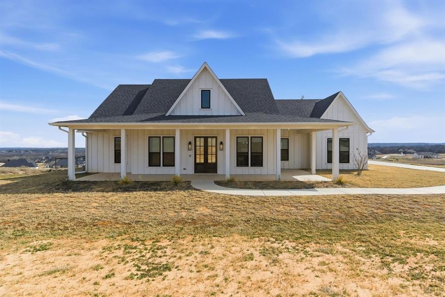 Recently appraised at $518,000. Seller offering $5,000 concession to buyer. Situated on 1.124 acres with gorgeous hilltop views overlooking for miles and miles.  Step inside this like-new, 2022 build, 2,115 sqft, offering 3 bedrooms, 2.5 bathrooms, plus an office or flex space. This open concept home boast an oversized living area with vaulted ceilings, custom wooden beams, and a gas floor-to-ceiling fireplace. The kitchen has plenty of cabinet space, under-cabinet lighting, and gorgeous quartz countertops, ready for hosting or family gatherings. This split floor plan offers the master bedroom with an en-suite bathroom. Double vanity areas with a large soaking tub, a massive walk-in closet, and a shower. The two large bedrooms offer plenty of natural lighting with oversized walk-in closets in each. This property has an oversized two-car garage with plenty of additional driveway parking space. With a half wrap-around front porch and extended back porch, this property is ideal for evenings or early morning relaxing, enjoying the country scenery it offers. The back porch is plumbed for a gas outdoor kitchen or grill. Being minutes away from Springtown, TX, this home is the perfect blend of exclusivity with the convenience of being just outside the city limits.
