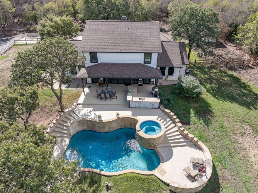 Amazing & Unique Remodeled Farm House.  Lake Lewisville access! This land backs up to Corps land, nice for trails and Lake Lewisville access.  This is a great Property for an Equestrian lover or other farm animals with over 5 acres that includes a 5 stall barn with heated and cooled tack and feed room. The main house sits at the back of the property, giving lots of peace and quiet. Property has a spacious and open floor plan with back wall of Glass windows and doors than can be opened up into back patio oasis, complete with outdoor kitchen, pool, and hot tub.  The home has Large bedrooms and a 2nd primary bedroom upstairs.  4 bedrooms and 3.5 baths. Back corner of property has gate to access Lake Lewisville, giving access to Lake, and Nice trails for walking or riding back to the Lake Lewisville. Property has lots of trees and wonderful landscaping on sprinkler system. Pool and hot tub equipment can all run off apps. The property also has a 3 bed 2 bath quest house attached to barn, that has been a great make AirBnB, rental, or grounds keeper home. It has been remodeled as well. The Kitchen is spacious with an island and bathrooms are nice size. The second home is not traditional and would need some remodel. Owner financing available with minimum 25% down and 5% interest, 15 yrs max. The property has a seasonal creek run most of the year, two pastures, extra large chicken coop and lots of privacy. You are close to everything as well. Front pasture has area that was graded for arena directly across from barn double doors. This property is ag exempt too!!
***Agent to verfiy all information***