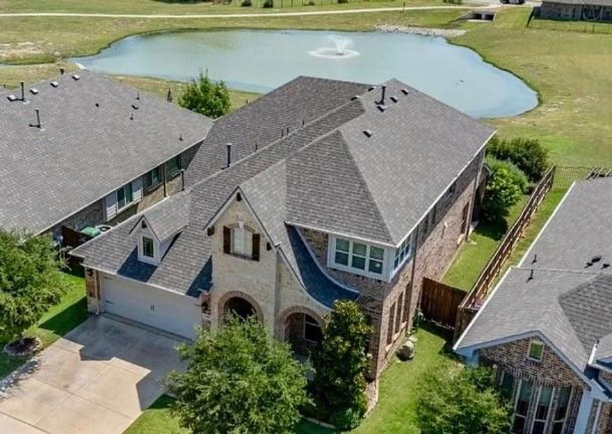 Welcome to your dream home in the sought-after Country Lakes community of Denton, TX! This elegant two-story residence offers the ideal blend of comfort, style, and space. Enjoy peaceful views of the adjoining greenbelt and tranquil pond with fountain, all visible from your beautifully landscaped backyard. The backyard itself offers a serene setting with lush greenery and a covered patio—perfect for unwinding or hosting gatherings.
From the moment you arrive, you’ll notice the eye-catching, bright green landscaping. Inside, you’re welcomed into a thoughtfully designed layout featuring four bedrooms, 2.5 bathrooms, and three separate living areas, offering plenty of room to live, work, and relax. A dedicated home office at the front of the home is filled with natural light and can also function as a formal dining space.
The heart of the home is the spacious kitchen, which truly shines with abundant counter space, sleek white cabinetry, and a massive walk-in pantry—a perfect setup for both entertaining and everyday living. The main living room is warm and welcoming, centered around a beautiful stone fireplace. Large windows overlook the peaceful pond and fountain, bringing relaxing views right into your everyday routine.
Upstairs, you’ll find three additional bedrooms and two versatile living areas that can serve as a media room, game room, or lounge—tailored to fit your lifestyle. Notable updates include a new roof installed in May 2025, giving you added value for years to come.
Living in Country Lakes means enjoying an active, connected lifestyle. Incredible neighborhood amenities are just steps away, including extensive walking trails, greenbelts, multiple ponds and parks, a dog park, two sparkling community pools, and playgrounds—something for everyone to love.