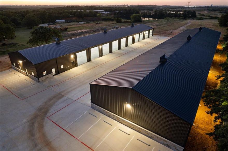 Priced to sell, this amazing turnkey property is perfect for the owner user or seasoned investor.  KEY POINTS ARE NO CITY TAXES LOCATED IN THE KENNEDALE ETJ.  Approximately 14 acres located in Fort Worth, only 4 miles south of I-20 and US 287.  Close proximity to I-35, FM 1187, and Hwy 360.  Brand New Rock Column Fence and Hardscape Landscape gives this property the ultimate curb appeal.  Brand New 2025 Construction of 2-50'x240' free span buildings being 12,000 sq ft for a total of 24,000 sq ft.  16' wall height with 23' center.  Each building can be divided into 4 suites if needed. Plenty of room for Motorhomes, Boats, RV's, Charter Buses, Equipment, the uses are endless.  A total of 22 power 14'x14' overhead doors that are fully insulated and can be controlled by an app with multiple users or from each door controller.  These doors are extremely quiet when opening and closing. Site Plan has room for an additional 6-12,000 sq ft buildings. Great for additional income producing buildings as an owner user or investor. Front concrete circle drive with additional concrete parking and yard or equipment parking.  Each building is fully lighted inside and out.  The outside lights are on photocells to conserve energy and add increased security. 1,500 sq ft office with a total of 6 offices prewired for data ports.  Fiber Optic Now Available.  New Central HVAC in office.  Upgrade Office Doors with security locks.  Do you need yard space, this property offers plenty of yard space for any need.  The back of the property has approximately a 4 acre pond with incredible park like views.  The North end of the pond has a cliff with hiking trails and perfect for park benches to watch the seasonal ducks and geese or just to watch the fish below waiting to be fed. The pond is fully stocked with Large Mouth Bass, Catfish, and Perch.  There are 2 floating fish feeders on timers in the pond.  This ONE-OF-A-KIND PROPERTY has so much to offer with endless possibilities and uses.