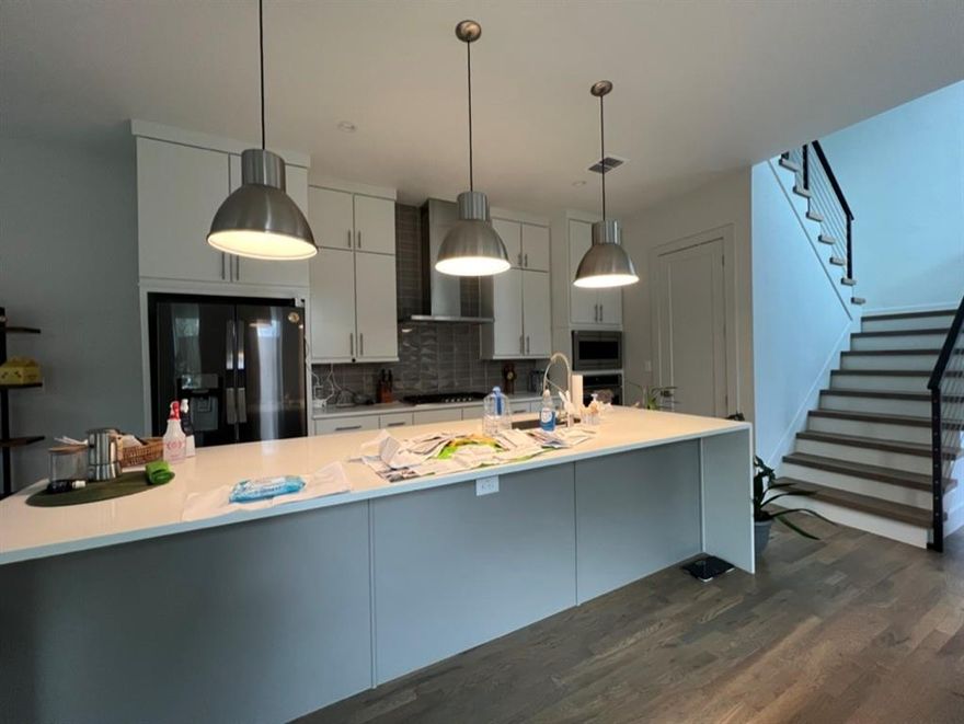 Expansive, airy floor plan flooded with sunlight welcomes you into this contemporary home. Indulge in culinary delights within the chef's kitchen, featuring a sprawling island adorned with elegant waterfall quartz countertops and stainless steel appliances. Hardwood floors gracing all bedrooms, while a dedicated laundry room offers convenience with built-in cabinets. The opulent master suite beckons with a generously sized shower and a sleek freestanding modern tub, providing a sanctuary of relaxation. The home features robust 2x6 framing and FOAM insulation, ensuring remarkable energy efficiency. Tall sliding doors effortlessly merge indoor and outdoor living, leading to a secluded back patio enclosed by 8-foot horizontal board-on-board fencing. Situated in an ideal locale mere minutes from Downtown, Uptown, and the vibrant Lower Greenville, this residence epitomizes urban sophistication and convenience.