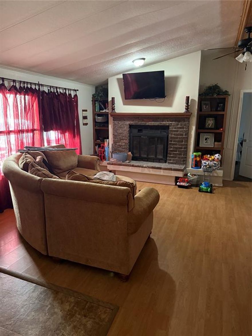 Doublewide situated on three lots totaling over half an acre! This retrofitted home offers a spacious 3-bedroom, 2-bath split floor plan, providing privacy and functionality. The property is fully fenced with barbed wire and sits in a quiet neighborhood with a peaceful country feel, while still offering convenience. Plenty of room for outdoor living with front and back wooden porches, room for animals, or future improvements. A great opportunity for those looking for space, privacy, and immediate occupancy. Lots 28 ,29 and 30 are all included with the doublewide.