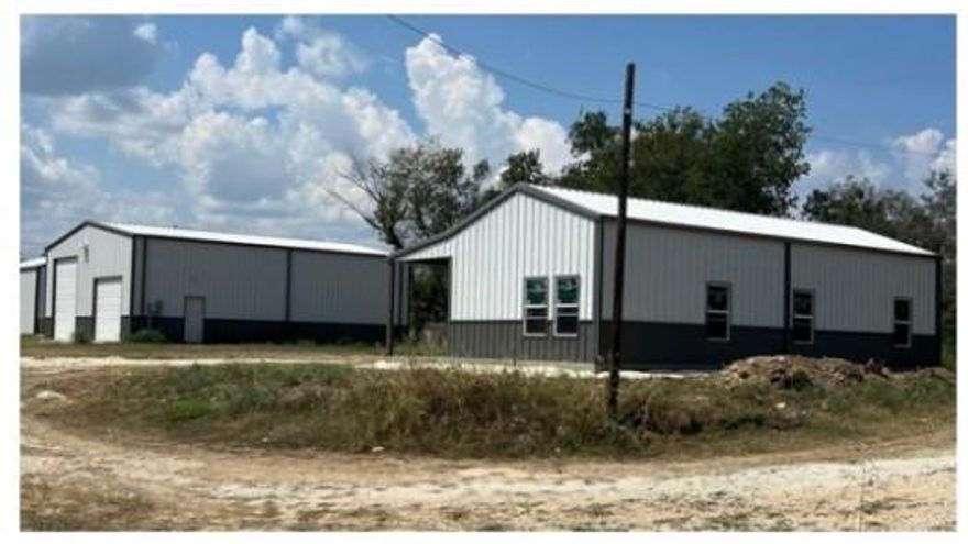 Lake Whitney Barndo for sale. The building is 40 feet by 50 feet in length. It is designed for parking your RV on one side with all the hook-ups in place and building out the other side with living quarters. There is a new septic system, water meter, and electricity already established.