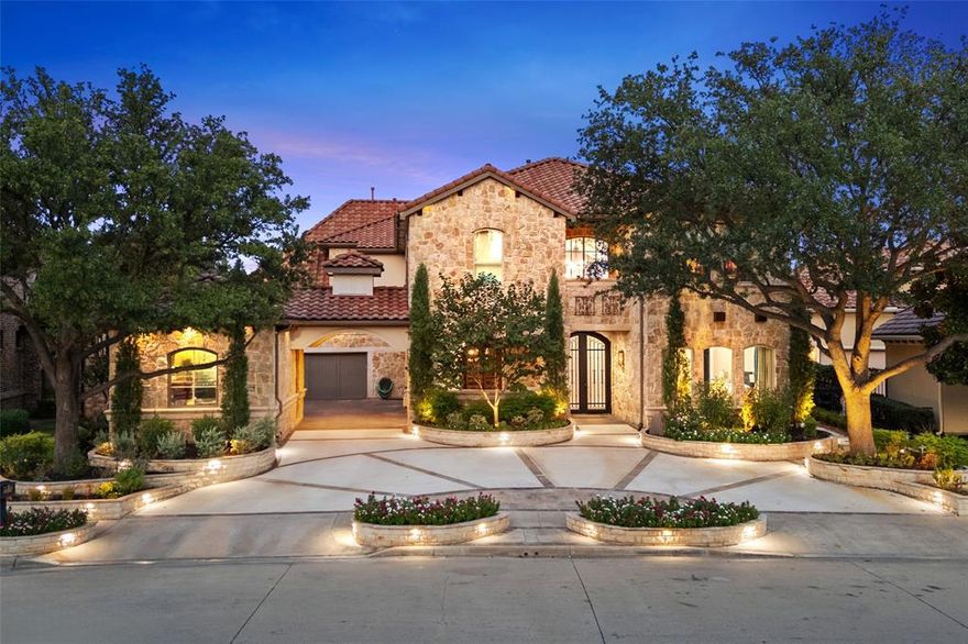 Welcome to this extraordinary 6,227 sq. ft. home with serene PARK AND WATER views in sought after Stone Creek in Frisco ISD. Stunning architecture, lush landscaping, unforgettable curb appeal set the stage for a lifestyle of elegance and comfort. Step inside the soaring two-story foyer and be captivated by tumbled stone floors, rich finishes, and thoughtful architectural details. An executive office features custom built-ins and a cozy fireplace. The sunken, temp-controlled 700 bottle wine grotto is perfect for showcasing your collection. The kitchen is a chef’s dream, boasting dual professional-grade KitchenAid stovetops and ovens, a built-in refrigerator and a massive center island. An adjoining hearth room with a warm fireplace flows seamlessly into an impressive great room with soaring beamed ceilings and a dramatic floor-to-ceiling stone fireplace. A spacious laundry and mud room with built-in lockers provides a stylish, functional space to keep everyday essentials neatly organized. Step outside and discover your private resort-style backyard. Multiple waterfalls cascading into a sparkling pool and grotto with a hot tub. A wraparound patio with fire pit and covered outdoor patio with fireplace perfect for cozy evenings. The main level also includes a large guest suite with ensuite bath. Upstairs, the primary suite is a sanctuary. Wake up each morning to tranquil park views and enjoy a private coffee bar, two-way fireplace, and your own terrace with a spiral staircase leading down to the pool and hot tub. The spa-inspired primary bath and a Carrie Bradshaw–worthy custom closet—complete with its own private laundry room. 3 additional ensuite bedrooms with private balconies plus a spacious game room and mid-level landing provide plenty of space for everyone to relax. 3 car garage with ample guest parking. Located within the highly acclaimed Frisco ISD. Minutes from shopping, dining, major thoroughfares. Luxury living at its finest. Over $200K in recent upgrades.