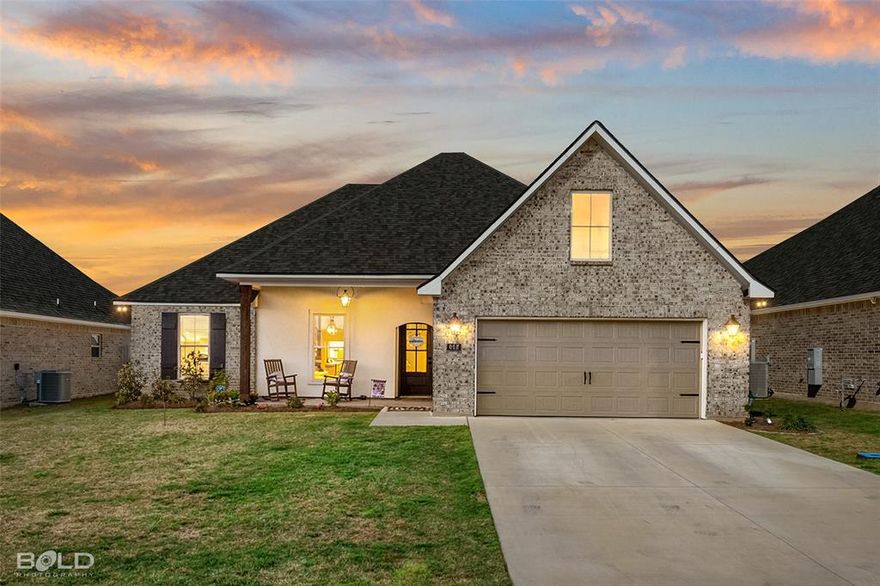 Like new construction in Lost River Estates in Benton! This IRISES V B open concept floor plan features 4-bedrooms, 2-bathrooms, 1,961 square feet and is ready for its new owners! The main living area features plenty of natural light, a gas fireplace complete with granite surround, and flows seamlessly to the kitchen, creating a functional space for everyday living as well as gatherings and entertaining. The kitchen features stainless appliances, upgraded granite countertops, 5 burner gas range, generous counter space and a large walk-in pantry that provides exceptional storage. The primary suite is designed to offer both comfort and privacy, while the primary bathroom includes a large vanity with two sinks, relaxing garden soaking tub, custom tiled shower with frameless shower door and a spacious walk in closet provides ample storage and organization. Three additional bedrooms provide flexible space for family, guests or working from home. Featuring ceramic wood look tile in the main areas and carpet in the bedrooms, as well as under mount sinks throughout, you’ll also have the added convenience of a smart connect Wi-Fi thermostat, upgraded paint, crown molding, LED lighting package throughout, LED pendant and recessed lights in the kitchen, tankless water heater, Low E tilt-in windows, and a covered back patio, perfect for entertaining! Enjoy the convenience of a two car garage and beautiful curb appeal, this move-in-ready home truly has it all and no detail was spared! Conveniently located near I-220, I-20, Barksdale Air Force Base, hospitals, shopping, dining, and within the highly sought-after Benton school district, this exceptional Benton home offers the ideal blend of location, condition, and lifestyle.
