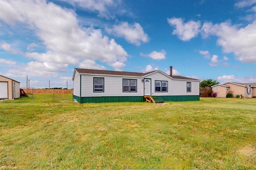 NEW LOWER PRICE — ACREAGE LIVING MINUTES FROM THE CITY! Come get this deal fast! 

1406 Grand Prix Court, Rhome TX
Escape to peaceful acreage living while staying just moments from city convenience! This beautifully updated 4-bedroom, 2-bath home sits on over one acre at the end of a quiet cul-de-sac—just 30 seconds from Highway 114 and only 5 minutes from the Texas Motor Speedway.

Step inside to discover an open-concept layout flooded with natural light, creating a warm and welcoming setting for family and friends. The kitchen is modern and spacious, boasting abundant cabinetry, generous counter space, and an effortless flow into the living area—perfect for entertaining or everyday living.

Retreat to the primary suite featuring a private ensuite bathroom, while the additional bedrooms give you flexibility for guests, home office, or hobby space.

Recent updates make this home genuinely move-in ready: new roof & windows (2024), fresh siding, skirting, paint and seals (Nov 2024), and new carpet (2022).

Outside, your private backyard oasis awaits—mature trees, wide open skies, and plenty of space for gardening, pets, or relaxing evenings under the stars. A detached garage workshop adds even more value, offering ample space for storage, projects, or a creative studio.

Properties like this—an acre, upgrades, and unbeatable location—are rare in Rhome! With this new lower price, the home is truly priced to sell and ready for its next owner.

Enjoy the best of North Texas living—minutes from Fort Worth, Alliance Town Center, top shopping and dining, and major highways. Don’t wait—schedule your showing today and experience all that 1406 Grand Prix Court has to offer!