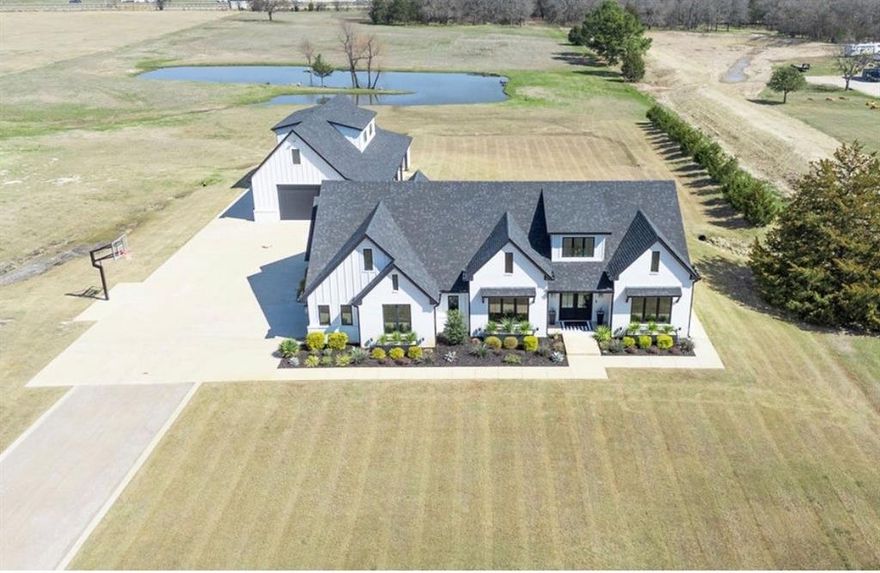 Experience refined country living with this smart luxury estate just minutes from Interstate 20, offering 4,415 sq ft of total living space across two stunning homes ideal for multi generational living, guests, or income potential. Thoughtfully designed for comfort, technology, and timeless style, this property delivers upscale finishes and a serene, modern country lifestyle on two beautifully landscaped acres.

The main residence spans over 2,600 sq ft and features 3 bedrooms, 3 bathrooms, plus a large office with a full size closet that can serve as a fourth bedroom. The chef’s kitchen dazzles with white-oak cabinetry, elegant granite countertops with a waterfall-edge island, a 48 inch ZLINE LP gas range, Decor panel front refrigerator, and ZLINE panel front dishwasher. Open concept living spaces flow seamlessly, with natural light accentuating the home’s craftsmanship and contemporary finishes.

The second home, at over 1,800 sq ft, is a retreat of its own, perfect for extended family or rental income. It includes 2 bedrooms, 2 full baths, a large game room, two spacious living areas, a private balcony, and a huge outdoor patio with a gas fireplace, ideal for entertaining or quiet relaxation.

Both homes feature epoxy chip-seal garage flooring, smart-home technology, and are surrounded by impeccable outdoor design, lush landscaping, custom irrigation, and metal planter boxes that highlight the property’s sophisticated curb appeal. Unwind in the luxury Coast Spa hot tub, and enjoy the peace and privacy of country life without sacrificing convenience.

This one of a kind estate blends innovation, craftsmanship, and natural beauty, a truly exceptional property designed for modern living in a tranquil setting.