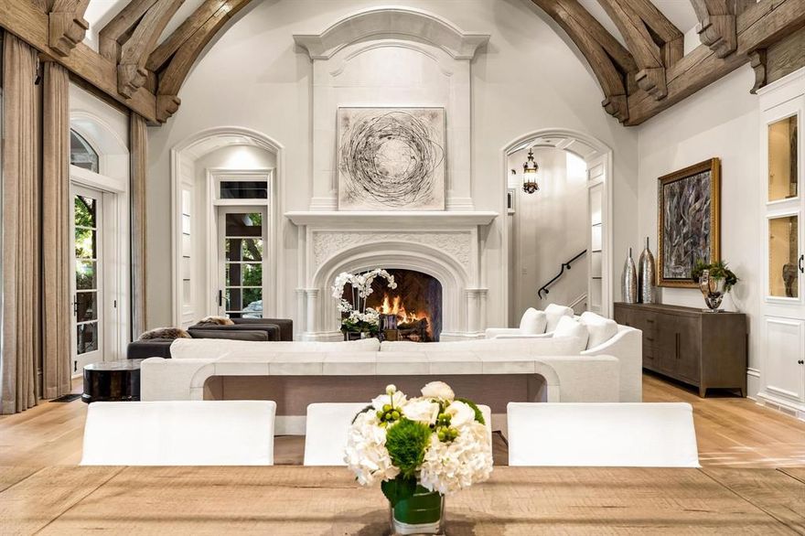 Exuding elegance & comfort, this magnificent home is located in the coveted Los Arboles community. Stunning renovation coupled with exquisite architectural details creates serene & comfortable living overlooking the beautiful lake.Each space was meticulously redesigned with the highest quality materials creating a cozy yet sophisticated feel throughout with bright & open spaces.Grand foyer leads to formal dining with a stunning fireplace, & natural light that cascades in. Great room with its stunning wood-beam cathedral ceiling, stone fireplace & french doors bring the outdoors in while overlooking the lake, pool & patio.Gourmet kitchen is spacious with an abundance of cabinets, gorgeous island, quartzite countertops, all open to the great room for entertaining & family living.Primary suite is a perfect retreat with fireplace, sitting area overlooking the lake, his & her baths, & custom closets. A library, exercise room, craft room, elevator, & 3-car garage complete this masterpiece.