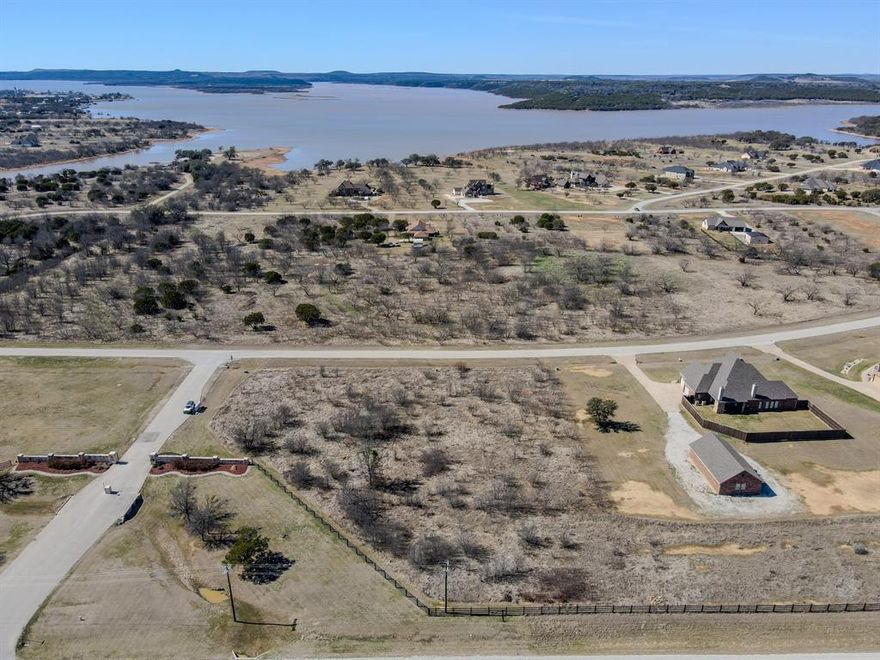 Build your dream home on this exceptional 1-acre homesite in The Hills Above Possum Kingdom, one of the lake’s premier gated communities. Offering the perfect blend of privacy, space, and natural beauty, this property gives you room to design the ideal full-time residence or weekend retreat. Residents enjoy access to outstanding amenities including a private boat ramp, resort-style community pool, clubhouse, fitness center, and secure gated entrance. Whether you’re spending the day on the water or relaxing with friends and family, this community is designed for the Possum Kingdom lifestyle. With co-op electric and co-op water already available, this lot is ready for you to start building. Don’t miss the opportunity to create your custom lake escape in one of PK’s most desirable neighborhoods.