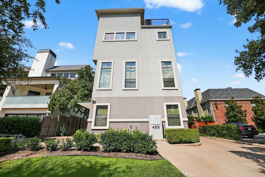 Four-level, 3 BR, 3.5 BA home with 2-car attached garage in prime Dallas location. First-floor guest suite with full bath. Second level features open living room kitchen with soaring ceilings, abundant natural light, fireplace, hardwood, tile, slat, carpet floors, custom cabinets, stainless appliances, vessel sinks, and plantation shutters. Third-floor primary suite offers decorative fireplace, jetted tub, large shower, dual vanities, and walk-in closet. Fourth floor includes media room, wet bar, and rooftop deck with stunning downtown views. Full-size washer dryer included. Close to The Shops of Highland Park, Oak Lawn, Turtle Creek & Katy Trail.