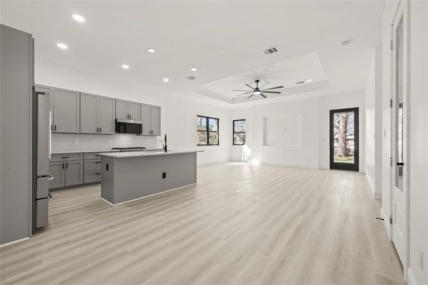 Stunning new construction just minutes from Downtown Dallas and steps from the State Fair of Texas, located on a rapidly transforming street surrounded by other recent modern builds. This modern 4-bedroom, 2-bath home features an open-concept layout ideal for everyday living and entertaining, with a show-stopping kitchen offering sleek gray cabinetry, quartz countertops with a full quartz backsplash, a walk-in pantry, and premium Bertazzoni appliances including a 5-burner Master Series range and a 36-inch Professional Series 4-door French door refrigerator. The private primary suite is tucked at the rear with a spa-inspired bath featuring a soaking tub, separate shower, LED-lighted mirror, and walk-in closet. Solid-surface flooring runs throughout, and a covered patio off the living room extends the living space outdoors. Builder-forward details include a custom inset TV niche, while the exterior impresses with a modern stucco façade, black luxury Pella windows, contemporary driveway design, and fresh landscaping. Special lender rate buy-down available with preferred lender.