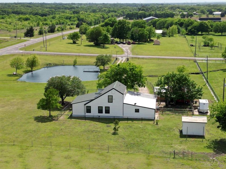 MOTIVATED SELLER!  Experience the perfect balance of country tranquility and modern conveniences in this beautifully updated Modern Farmhouse.  This 2.5 acre property is located at the corner of FM 1390 and Co Rd 4100--that's just minutes from US-175.  This property is fully fenced with newly installed metal-iron fencing and gated entry.  The peaceful pond creates a calming backdrop that turns everyday moments into life-long memories.  The front door entry has been reconfigured to welcome you into an open-floor concept that encompasses a newly added foyer, updated Kitchen, Living Room with newly installed electric fireplace, a newly added Dining Room, and newly installed durable Luxury Vinyl Plank flooring throughout the first floor.  This open footprint creates effortless flow for entertaining and daily living.  The Kitchen has been updated to included a walk-in Pantry, a secondary pantry for your smaller appliances, and a newly added half-bath for your guests.  The Primary Bedroom has a huge walk-in closet with a laundry area. The updated ensuite has a newly installed walk-in shower and surround.  The two secondary bedrooms are upstairs with an updated bathroom that offers fresh paint, flooring and granite vanity.  The property has incredible parking space, workspace options and plenty of storage spaces.  17 x 25 workshop includes electrical with front and rear sliding doors.  The property also includes a 14 x 14 wood building--great for horse stall, chicken coop or extra storage.  Enjoy the perfect balance of modern touches and relaxed rural living.   No HOA, serene views and modern comforts!  Make your viewing appointment today.