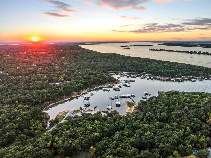 LAKE TEXOMA WATERFRONT COMMUNITY! Discover your dream getaway at this idyllic lakehouse nestled in the waterfront Cambridge Shores community that overlooks the renowned Islands of Lake Texoma. This property offers not just a home, but a lifestyle immersed in the beauty and excitement of lake living. Situated on a generous 1.27-acre lot, this modern design seamlessly blends contemporary aesthetics with natural surroundings. Originally built in 1984, the home has undergone a meticulous transformation, stripped down to the studs and thoughtfully rebuilt in 2022. As you step inside, you'll be greeted by beautiful finishes that enhance the open-concept layout, allowing for an effortless flow between living spaces. The roofline windows invite an abundance of natural light. Step outside onto the double wrap-around covered decks—perfect for entertaining guests and relaxing. The solid construction features durable fiberboard siding topped with a sturdy metal roof, ensuring your investment stands the test of time. Spray foam-insulated walls and attic create an energy-efficient environment. The property includes a detached garage with electricity and a second concrete driveway, providing ample parking and storage. A fenced yard provides security and privacy, while the firepit area is an ideal spot to gather around the flames under a starry sky. Mature, plentiful trees surround the property, creating a serene oasis where you can unwind amid the natural surroundings. This lakehouse isn't just a beautiful retreat; it's an ideal investment opportunity. With the potential to add additional units, you can tap into lucrative short-term rental income. Residents of Cambridge Shores enjoy community amenities, including a boat ramp and pier, making it easy to access the water. Conveniently located near Highport Marina, delightful restaurants, and the Tanglewood Resort and Golf Course.  Embrace the allure of lake life—make this exceptional property your own!