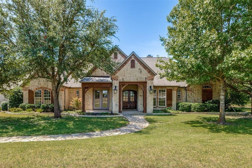 Welcome to your own private Texas retreat! Nestled on 11 ag-exempt acres in the Hills of Lone Star, this extraordinary property offers the perfect blend of luxury living and wide-open space. A private gated entrance leads you into a serene landscape with cross-fenced pastures, ideal for horses or livestock. The property includes a barn with water and electricity, a tack room, a feed room, a loafing shed, and a wash rack—everything you need for country living without sacrificing comfort.  

The beautiful custom-built home is designed and crafted with attention to detail.  Warm wood floors flow throughout. The main living area is stunning, with soaring ceilings accented by reclaimed wood beams imported from Pennsylvania, which add rustic elegance and architectural charm. Enjoy the beauty of nature from indoors with the stunning, oversized windows.   

The open-concept kitchen is a chef’s dream, with high-end stainless steel appliances, pull-out drawers in cabinets, a warming drawer, an appliance garage. The farm sink paired with natural stone countertops adds a touch of warmth and timeless elegance to the kitchen. A wine cellar area completes the space, making it perfect for entertaining or relaxing evenings at home.

Surrounded by mature trees and secluded from the hustle and bustle, this property offers peace, privacy, and the opportunity to live your dream lifestyle. The fenced backyard creates a cozy, enclosed retreat while still being embraced by the privacy of surrounding trees.  

The 3-car oversized garage setup includes space for a workshop and even its own half bath, making it the ultimate escape for hobbyists or tinkerers. Whether you're raising horses, enjoying nature, or simply unwinding in a luxurious country setting, this home has it all.

Don't miss the chance to own this one-of-a-kind property with timeless craftsmanship.