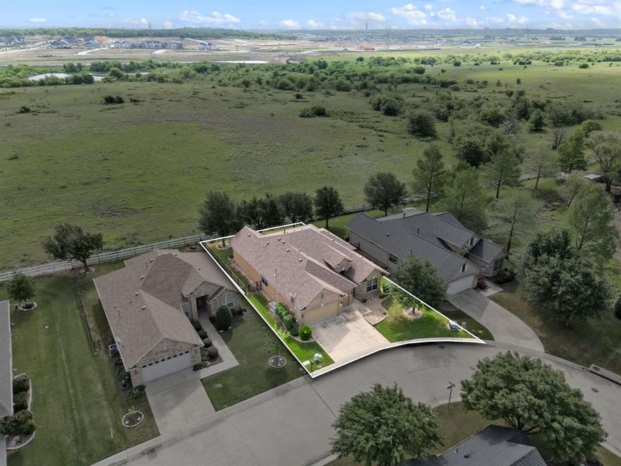 Welcome to easy, elevated living in the highly sought-after Robson Ranch, an exclusive 55+ guard-gated community where lifestyle meets comfort. Perfectly positioned backing to a peaceful greenbelt, this beautifully maintained single-story home with a three-car garage offers the space, flexibility, and serene setting you’ve been waiting for. Step inside to a light-filled, open-concept layout designed for both everyday living and effortless entertaining. The expansive living room is warm and inviting, featuring a cozy fireplace and easy-care tile flooring that makes maintenance a breeze. The kitchen is truly the heart of the home, complete with a large granite island, gas cooktop, abundant cabinetry, and a bright breakfast nook with charming bay windows. Just beyond, a stunning sunroom creates the perfect space to relax year-round while taking in tranquil views of the lush backyard and greenbelt, your own private retreat. The oversized utility room is incredibly functional, offering a sink and extensive cabinetry for storage and organization. A convenient half bath is ideal for guests. The spacious primary suite is a true haven, featuring crown molding, a ceiling fan, and private access to the backyard. The ensuite bath includes dual sinks and a separate shower for comfort and convenience. A well-sized secondary bedroom, full bath, and a versatile third bedroom, perfect as a home office or hobby space, complete the interior.  Living in Robson Ranch means embracing a vibrant, resort-style lifestyle with unmatched amenities, including golf, a clubhouse, fitness center, indoor pool, sports courts, scenic lakes, and a full calendar of community activities. This is more than just a home, it’s a lifestyle. Move-in ready, beautifully cared for, and set in one of the area’s most desirable active adult communities, this is a must-see.