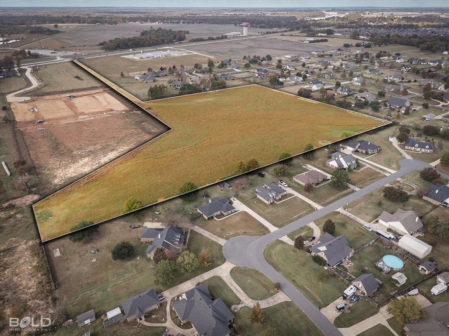 Positioned along the highly traveled Benton Road corridor in North Bossier, this 17.18-acre tract offers an excellent opportunity to acquire prime development land in one of the Shreveport-Bossier market’s fastest-growing areas. Located just north of Vanceville Road at the terminus of Britton Road, the property provides strong visibility and convenient access while maintaining privacy and flexibility for development. The site features generally level terrain with natural drainage and open pastureland, creating a solid foundation for future development. Public utilities including city water, community sewer, electricity, natural gas, and telecommunications are available in the area. The tract benefits from direct access to Benton Road via an approximately 86-foot-wide access corridor, providing efficient entry and excellent frontage exposure. Zoned R-A (Residence Agricultural District), the property is well suited for rural residential or subdivision development, supporting estate-style lots and residential growth consistent with surrounding patterns. Nearby land uses include established neighborhoods, expanding subdivisions, community facilities, and additional development tracts, reinforcing strong long-term housing demand. Strategically located north of Interstate 220, the property offers convenient access to Benton Road, Airline Drive, Swan Lake Road, and I-220, allowing easy connectivity to Bossier City, Shreveport, Barksdale Air Force Base, major healthcare facilities, retail centers, and employment hubs. Most of the property lies in Flood Zone X, with only a small portion in Zone A. Whether planned for subdivision development, estate-style homesites, or long-term investment, this tract offers scale, location, and development potential rarely found in today’s market.