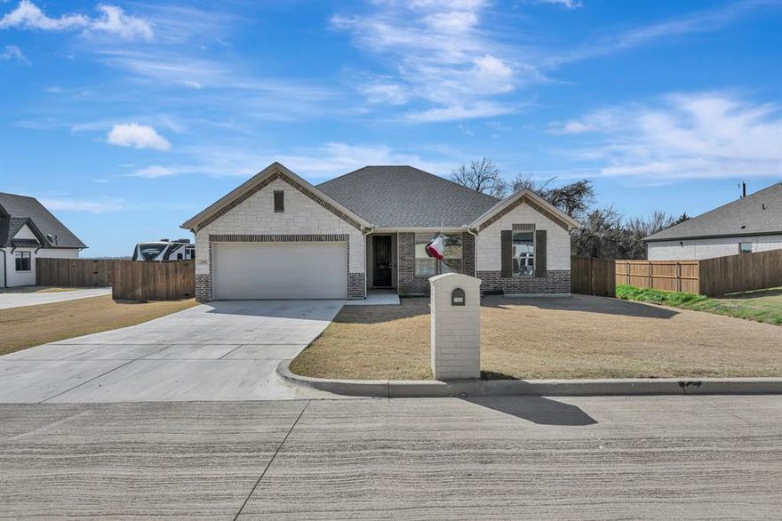 This beautifully maintained home combines comfort, style, and an unbeatable location to create the perfect place to put down roots. From the moment you arrive, the striking brick and stone exterior delivers inviting curb appeal. Inside, luxury vinyl plank flooring flows through an open concept layout designed for both everyday living and effortless entertaining. The spacious living area connects seamlessly to a stunning kitchen featuring granite countertops, stainless steel appliances, a large island with breakfast seating, and a generous pantry for added storage. The private primary suite is truly a retreat, offering plenty of room to unwind along with a massive walk in closet. The spa inspired bath includes dual vanities, a separate shower, and a relaxing garden tub. Step outside to enjoy a large covered patio that overlooks an open field with no backyard neighbors, providing peaceful views and extra privacy. Located within walking distance to the stadium and convenient to local amenities, this home checks every box for families and entertainers alike. Schedule your private showing today and see why this one feels like home the moment you walk in.