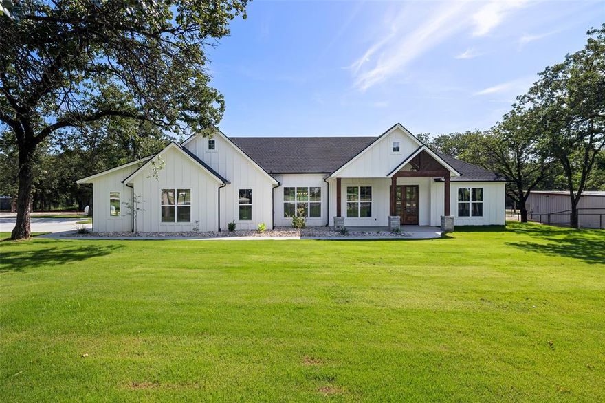 CHARMING MODERN FARMHOUSE in the country nestled among tall oak trees. This comfortable farm style home, centered on 1.76 acres, with plenty of elbow room for pets, a horse, chickens, garden, and pool, is designed for entertaining and everyday living. Inviting front porch. Boasting an array of sleek finishes and open layout. Beautiful stone fireplace and engineered wood flooring. The gourmet kitchen features handsome knotty alder cabinets, granite, SS appliances, gas cooktop and huge pantry. Adjoining dining room has great views. Roomy walk-in shower & slipper tub in primary bath. Split bedrooms. House and garage fully foam-insulated. Storage barn-workshop out back. Concrete driveway from street to garage with lots of parking area. Pipe fence on front with electronic gate opener. Property has its own new well. Sprinkler system and new sod. RV hookup. Place to hook up a generator. Room to park boat. Please refer to transaction desk for specifics, warranties, etc. Home can also be purchased with adjacent property and improvements for $975,000. See MLS# 20970641. Ask about Seller financing.