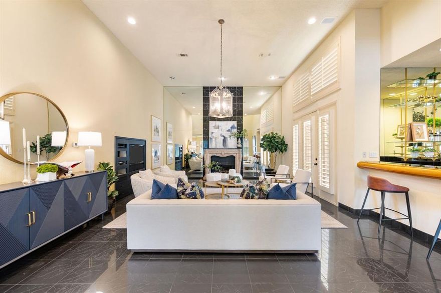 This stunning Mediterranean style home is incredibly unique with so much character! Pull into the circle drive and enter through the gated atrium-style front porch that features a large tree growing up through the second-story balcony. Step into the Carrara Marble entry and up the steps to the oversized family room, complete with a full-sized wet bar, soaring ceilings, a wall of mirrors framing the gas fireplace, and multiple entrances to the courtyard areas and backyard. The kitchen features a 6 burner gas stove-top, a built in Sub-Zero refrigerator, double ovens, a built in wine cooler, built in wine racks, trash compactor, warming drawer, an additional drawer-style dishwasher for pots and pans, and an electric fireplace and wet bar in the breakfast area. Additional features throughout are an intercom system, plantation shutters, and skylights that bring in so much natural light! The oversized primary bedroom features a seating area, a gas fireplace, double doors heading out to the pool, and of course an oversized ensuite bathroom with a standing shower, jetted tub, double vanities and large walk-in closet. The office features a full ensuite bathroom and there's a hidden space for a safe behind the book shelf! Upstairs you'll find 3 additional bedrooms (one currently set up as a workout room with a mirrored wall), 2 full bathrooms and ample storage. Out back you'll find several courtyard areas, a beautiful fountain, and the gorgeous saltwater pool and spa. This home is located just across the street from the private HOA tennis courts, playground, and a great walking trail through the hilly neighborhood. This home has unlimited potential and is priced to sell!