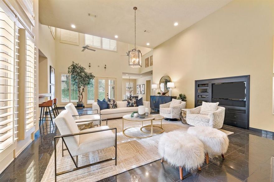 This stunning Mediterranean style home is incredibly unique with so much character! Pull into the circle drive and enter through the gated atrium-style front porch that features a large tree growing up through the second-story balcony. Step into the Carrara Marble entry and up the steps to the oversized family room, complete with a full-sized wet bar, soaring ceilings, a wall of mirrors framing the gas fireplace, and multiple entrances to the courtyard areas and backyard. The kitchen features a 6 burner gas stove-top, a built in Sub-Zero refrigerator, double ovens, a built in wine cooler, built in wine racks, trash compactor, warming drawer, an additional drawer-style dishwasher for pots and pans, and an electric fireplace and wet bar in the breakfast area. Additional features throughout are an intercom system, plantation shutters, and skylights that bring in so much natural light! The oversized primary bedroom features a seating area, a gas fireplace, double doors heading out to the pool, and of course an oversized ensuite bathroom with a standing shower, jetted tub, double vanities and large walk-in closet. The office features a full ensuite bathroom and there's a hidden space for a safe behind the book shelf! Upstairs you'll find 3 additional bedrooms (one currently set up as a workout room with a mirrored wall), 2 full bathrooms and ample storage. Out back you'll find several courtyard areas, a beautiful fountain, and the gorgeous saltwater pool and spa. This home is located just across the street from the private HOA tennis courts, playground, and a great walking trail through the hilly neighborhood. This home has unlimited potential and is priced to sell!