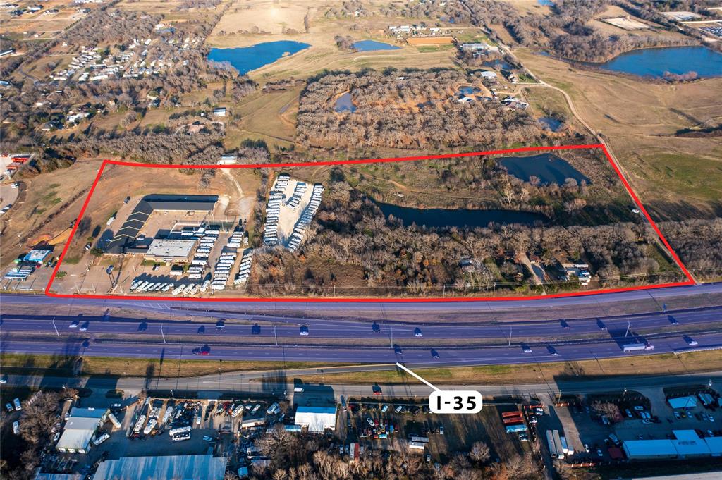 Amazing opportunity to own commercial real estate with over a 1,000 ft. of I-35W Highway frontage! 9 acres of commercial real estate with an additional adjoining 20 acres currently zoned ag. 20 minutes from downtown Ft. Worth! This motel currently has 60 furnished rooms and is being sold AS IS! Motel, additional building, and the RV dealership building are all being sold together.
