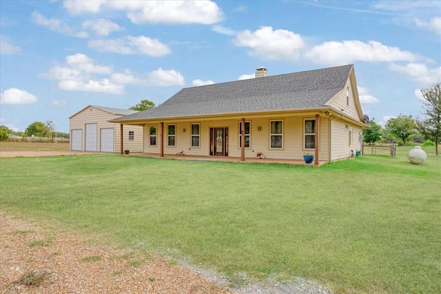 Presenting 7944 CR 669, Blue Ridge, TX USA. the perfect combination of a modern Texas farmhouse, on 5.24 acres, complete with a 30x30 workshop and a big tank. Location is important and you are positioned in Blue Ridge ISD, between Farmersville and Blue Ridge, close to State Highway 78, and an easy commute into the Sherman technology corridor, McKinney or DFW. Step inside to the expansive vaulted ceilings, showcasing wood rafters and a central brick fireplace. Yes, it's hot outside today, but you will appreciate the easy to use gas fireplace come winter. Turn the corner and relax in the massive primary bedroom, complete with an ensuite bathroom, offering a whirlpool tub, dual copper sinks and a walk-in custom shower. The kitchen showcases a copper farm sink, generous cabinets, wood counters and a gas stove. The second bedroom is a suite with access to the adjacent bathroom. Since the home is one and a half stories, you can escape upstairs to the secluded third bedroom. You will appreciate the spray foam insulated walls, a tankless hot water system and an attic with wood floors for extra storage. The recently built 30x30 workshop, on a concrete pad, with roll-up doors, is ready for your truck, tractor and side-by-side. Step outside onto the oversized front and back porches, enjoy the cooking shed and fenced backyard. The picture- perfect land is perimeter fenced on three sides, dotted with fruit trees and boasts a nearly half acre stocked pond. So, bring your fishing pole. Your cows will love it here. You don't have a cow, well, maybe you need one.  NO Deed Restrictions. NO Floodplain. The desirable Wilson Clay and Crocket Soils are rated for grazing through limited farming. Information is deemed reliable but Buyer should perform due diligence.