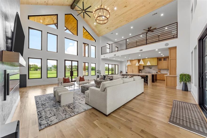 Discover this extraordinary custom luxury ranch estate on 11.969 ag-exempt acres between Sherman and Bells in sought-after Grayson County. This remarkable property offers the ultimate blend of refined living and country charm, featuring three versatile barns ideal for horses, cattle, or livestock, a peaceful seasonal pond, and a fully fenced perimeter with elegant iron posts for privacy and security.

Arrive through the grand gated entry, surrounded by mature trees, lush professional landscaping, and a covered front porch with sophisticated lighting. Inside, you’ll be captivated by soaring ceilings, an open-concept layout, and exquisite custom design details throughout — from the chef’s kitchen with top-of-the-line Gen Air Professional appliances, dual dishwashers, a built-in refrigerator freezer, and a dedicated wine room, to the stunning finishes and thoughtful craftsmanship in every space.

The main level features two spacious bedrooms with luxurious en-suite baths, a private home office, an elegant powder bath, and an oversized four-car garage complete with a dog wash station and electric vehicle charging outlet. Upstairs offers two additional bedrooms, a versatile family or game room, and an expansive covered balcony with panoramic ranch views.

The showstopping primary suite is a private sanctuary, boasting heated bathroom floors, custom walk-in closets, a sparkling chandelier, and a spa-inspired bath designed for pure relaxation. The property is pool-ready, with plumbing and electrical already in place, and also includes RV hookups and smart-home technology throughout.

This one-of-a-kind Texas ranch is perfect for animal lovers, equestrian enthusiasts, or anyone seeking a luxury retreat with extraordinary design and wide-open space. Don’t miss the chance to own this Grayson County masterpiece — schedule your private tour today!