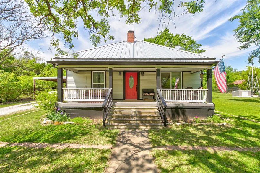 Step back in time while enjoying the comforts of today with this charming early 1900s county home. Nestled on beautifully maintained land surrounded by mature trees, this two-bedroom, one-bathroom retreat offers the privacy of rural living—without the long commute to town. Inside, the cozy living room invites you to unwind by the fireplace, the perfect place to warm up on crisp country evenings. The kitchen provides all the charm you'd expect, complete with abundant cabinetry that’s ready for your favorite cookware, mismatched coffee mugs, and perhaps a cookie jar or two. Take in your morning coffee or a sunset breeze on the welcoming front porch, practically designed for rocking chairs and relaxed conversations in mind. A durable metal roof adds both character and peace of mind, offering timeless appeal and long-term function. This home’s location strikes a balance between the quiet of the county and the convenience of being just minutes from the heart of town. It’s a true win-win for those looking to enjoy country charm without straying too far from the daily essentials. This home’s manageable size makes it ideal for those seeking simplicity, a weekend escape, or a peaceful full-time residence. With a little imagination and personal touch, this hidden gem could be your perfect slice of the countryside—no compass required.