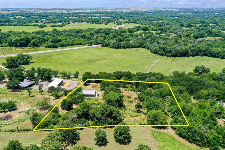 Beautiful view lot with like-new metal bldg on 3.11 acres in a prime location! This rare find is just minutes from the I-35 corridor, perfectly placed between Oklahoma City and the DFW Metroplex. Near Gainesville, the property offers a peaceful, park-like setting with mature trees, elevation changes, partial fencing, and stunning views from the top. The like-new 30’ x 40’ shop sits on a 30’ x 50’ concrete pad with an overhang, great for storage, hobbies, or future expansion. For those ready to build, there’s space to clear a homesite. Features include a gravel driveway, electricity on-site, and co-op water at the lot line. Nestled on a quiet, no-exit street in a sought-after area, it’s perfect for anyone wanting to build and enjoy tranquil country living with quick access to major cities.