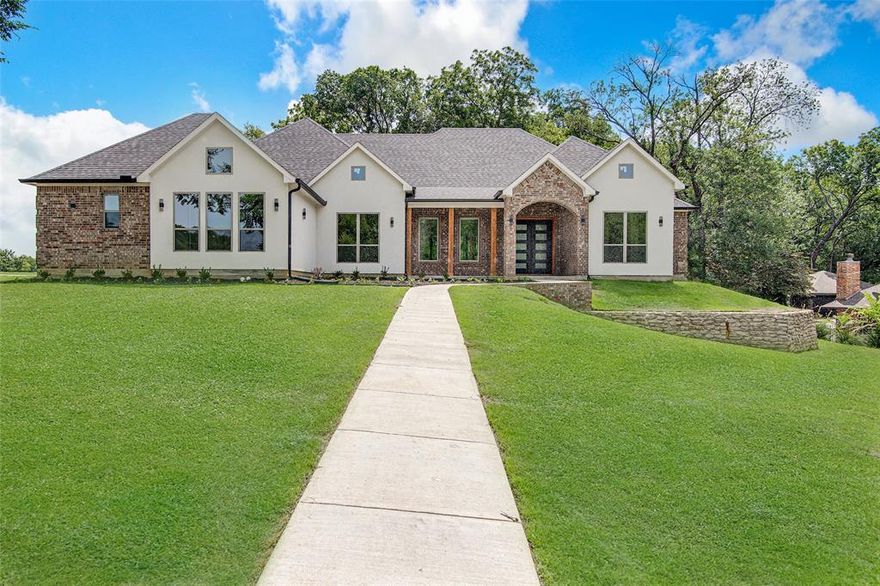 Brand-New Construction on 1 Acre! Welcome to this stunning 2,900 sq. ft. home that perfectly blends elegance, comfort, and functionality. Sitting on a spacious 1-acre lot, this home makes a grand first impression with beautiful double iron doors that open into soaring cathedral-style ceilings and an expansive living room. Large sliding glass doors lead to the backyard, filling the home with natural light and offering seamless indoor-outdoor living.
The gourmet kitchen is a true showstopper with abundant cabinetry, a striking waterfall backsplash behind the stove, built-in microwave, and a built-in ice maker—perfect for warm Texas days. A massive walk-in pantry with plentiful shelving ensures you’ll never run out of storage space. The dining area overlooks the backyard through oversized windows, making every meal a moment to enjoy the view.
This home offers 4 spacious bedrooms and 3 full bathrooms. The luxurious primary suite features a spa-like bathroom with a walk-in shower, standalone soaking tub, and dual vanities. The oversized walk-in closet is outfitted with custom shelving and connects directly to the laundry room for convenience. Two of the secondary bedrooms share a Jack-and-Jill bath, while the fourth bedroom has its own full bath access.
Outdoor living is just as inviting with large covered porches in both the front and back. Enjoy your morning coffee on the welcoming front porch and host family or friends on the expansive back patio—ideal for entertaining or simply relaxing.
Don’t miss your chance to own this thoughtfully designed new construction home with modern finishes, a functional layout, and space to enjoy both indoors and out.