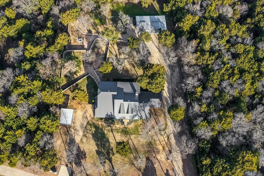 Experience privacy and luxury in this stunning custom home, set on a meticulously maintained 1.5 acre oasis with No HOA! Designed for both relaxation and entertaining, this spacious 6 bedroom, 3 bath home offers the perfect setting for hosting family and friends. Nestled towards the back of the property is a large three bay workshop with full HVAC and electrical providing ample space for boat or RV storage, personal workspace or even a batting cage! This exceptional home is a must see for those seeking luxury, convenience and outdoor adventure all in one!  Enjoy breathtaking views of Joe Pool lake and Cedar Hill State Park from the comfort of your own home. New hiking and bike trails along with multiple ponds for fishing are just steps away! Located right in the heart of DFW you're just a 25 min drive to both downtown Dallas and Ft. Worth.