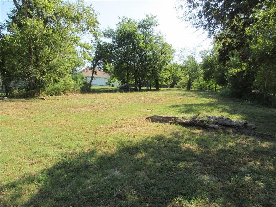 Just a short distance from Waco, and in the City of Groesbeck, is a large lot with road frontage on two sides.  Located at 406 S Whitt Street and just a block off of Hwy 164, this lot offers a range of possibilities! Presently there is an older home on the property that is used for storage.  You could possibly re-furbish or tear it down and build your dream home.  A Mobile Home is also an option.  The lot is cleared and has some perimeter trees.  Utilities should be available(Buyer check with City).  A Convenience Store is a block away facing Hwy 164, as well as a Dental Office and the Groesbeck Police Department.  Downtown Groesbeck is just a few blocks away.  Come and see this property today!  Don't miss out on this opportunity!