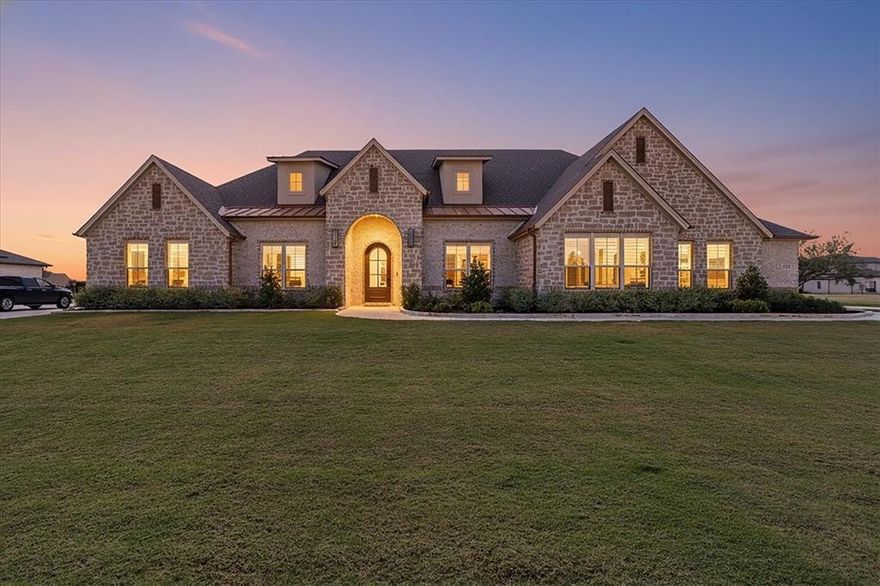 Looking for a newer home with some space? This is it!  Welcome to this gorgeous single-story home in Bella Crossing! Recently built by Couto homes, this showstopper was designed with every detail in mind. Complete with 4 bedrooms and 4 full baths, a private office, plus an additional bonus-media room and plantation shutters throughout. This one is the perfect combination of luxury and comfortable modern living. Upon entering, you will be greeted by the large living room, anchored by the impressive floor to ceiling fireplace, gleaming wood floors, expansive ceilings, and loads of natural light beaming in through the expansive windows. Equally stunning is the chef's kitchen, featuring two spacious islands, gorgeous combination of custom solid and glass cabinetry with lots of storage. Double ovens, gas stove, walk-in pantry, and adjacent butlers pantry allow for opportunities for entertaining small and large gatherings alike. The luxurious primary suite is a true retreat, featuring an ensuite bath with a gorgeous double vanity, custom-designed wet room with dual shower heads, a freestanding soaking tub, plus a stunning walk-in closet complete with built-in dressers and shoe storage.
A hard-to-find oversized four-car garage with insulated doors, epoxy flooring, and additional storage space provides both function and flexibility. The expansive 1+ acre lot offers endless potential—whether you envision a custom pool, putting green, or private sports court, there’s room to create your dream outdoor oasis.