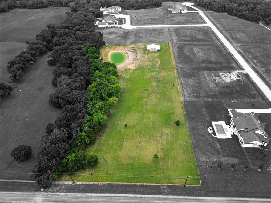 Rare opportunity in the rapidly growing community of Van Alstyne! Situated within the highly sought-after Van Alstyne ISD, renowned for its top-rated schools, this hard-to-find small acreage tract offers the perfect blend of space, privacy, and potential.

Enjoy the benefits of an agricultural exemption for lower property taxes while you plan and build your dream home. Bring your own builder and design exactly what you’ve envisioned.

Centrally located, the property is approximately 5 minutes from Highway 75, about 10 minutes to Sherman, and 15 minutes to McKinney—providing convenient access to shopping, dining, and major highways, all while preserving the charm of small-town living.

Backing up to large estate homes in the exclusive Enclave Subdivision, this 5+ acre property is fully fenced with pipe fencing along the front. A newly dug, expansive pond adds beauty and functionality, perfect for enjoying peaceful country views or watering livestock. A water meter is already installed, offering added value and convenience.

Additional improvements include a 30x40 insulated metal barn with an extended overhang—ideal for storage, animals, or hobbies. With a beautiful building site, this tract is ready for your forever home. The property can also be divided in half and allows for a guest home, providing flexibility for future plans.

Don’t miss this rare find in one of North Texas’s fastest-growing communities!