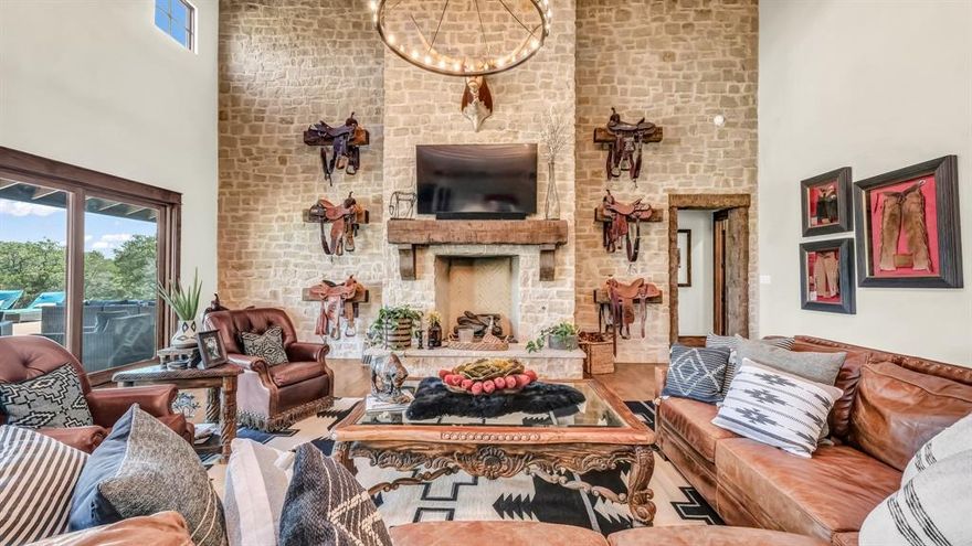 Nestled in the rolling hills of Mineral Wells, this remarkable 69± acre estate combines refined luxury with the serenity of wide-open Texas ranch land. At its center stands a custom 6,114± square-foot residence, thoughtfully designed with five bedrooms, five full bathrooms, and two half-baths. Every detail has been carefully curated, blending rustic elegance with modern convenience. Inside, you’ll find expansive living spaces anchored by a dramatic rock fireplace and soaring wood-beamed ceilings. The chef’s kitchen is a true showpiece, featuring premium appliances, dual dishwashers, a spacious pantry, and a functional layout designed for both entertaining and everyday living. You'll love the butler's pantry that provides additional storage. A wall of windows brings the outdoors in, connecting seamlessly to the back patio and sparkling pool, where sweeping views of the surrounding countryside set the stage for unforgettable gatherings. The master suite is a private retreat, complete with its own stone fireplace, spa-inspired bathroom, and an oversized closet with custom finishes. Additional bedrooms are equally well-appointed, offering comfort and privacy for family and guests alike. Beyond the home, the ranch is built for both leisure and function. Rolling pastures, mature trees, and ample space provide endless opportunities for recreation, livestock, or hay production. There is a seasonal creek that run through the property. The property also features a 125' x 250' covered arena-perfect for any discipline, an 18-stall horse barn, and a Priefert walker, making it ideally suited for any equine needs. This estate offers a rare combination of luxury, seclusion, and versatility—just minutes from Mineral Wells and within easy reach of the DFW Metroplex. This house is a rare find! It was recently featured in the Cowgirl Magazine!