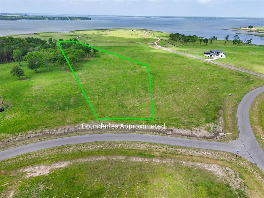 Build your dream home on the shores of one of North Texas’ most exciting new destinations—Bois d’Arc Lake—at 230 Lakewood Lane in The Shores at Peninsula. This exceptional homesite offers the rare opportunity to experience true lakefront living, where each day begins with tranquil water views and ends with breathtaking sunsets stretching across the western horizon. Imagine stepping out your back door for an evening stroll to the water’s edge, casting a line at sunrise, or simply unwinding as the lake reflects the changing colors of the sky. Whether you envision a weekend retreat or a full-time residence, this property invites you to design a lifestyle centered around relaxation, recreation, and connection to nature.
The Shores at Peninsula delivers a resort-style experience with thoughtfully designed amenities that elevate everyday living. Enjoy friendly matches on the pickleball courts, leisurely walks along scenic paths, or quality time with pets at the community dog park. Entertain effortlessly at the stunning multi-million dollar clubhouse, or spend your afternoons at the infinity-edge pool overlooking the natural beauty of the area. A putt-putt course adds a fun, casual touch for gatherings with family and friends. This gated community offers both privacy and prestige, developed with the high standards expected from a nationally recognized developer. With short-term rentals currently permitted (subject to light restrictions), this property also presents an appealing opportunity for those considering investment potential alongside personal enjoyment. Bring your own builder and create your vision on your timeline—no rush, just opportunity. As interest in Bois d’Arc Lake continues to grow, now is the time to secure your place in what is quickly becoming one of Texas’ premier lakefront communities.