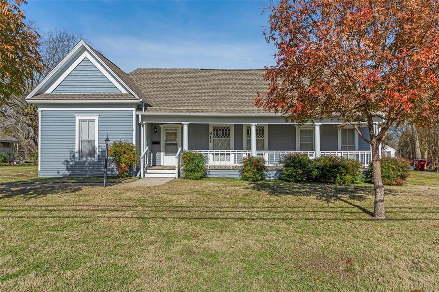 PRICE IMPROVEMENT! Welcome to this charming home set on a spacious 0.5-acre lot, surrounded by mature trees that offer both beauty and privacy. Relax and enjoy the outdoors from the inviting large front porch or the covered back patio, perfect for morning coffee or evening gatherings. Inside, you'll find large rooms throughout, including two living areas, each featuring its own fireplace for a warm and welcoming atmosphere. The formal dining room is ideal for hosting family meals and special occasions. The kitchen offers tons of storage space, decorative lighting, and room to work and entertain with ease. Outside, the property includes an extra-large garage or workshop, plus an additional shed, giving you abundant space for tools, hobbies, or extra storage. The large yard provides endless potential for gardening, play, or future outdoor projects.