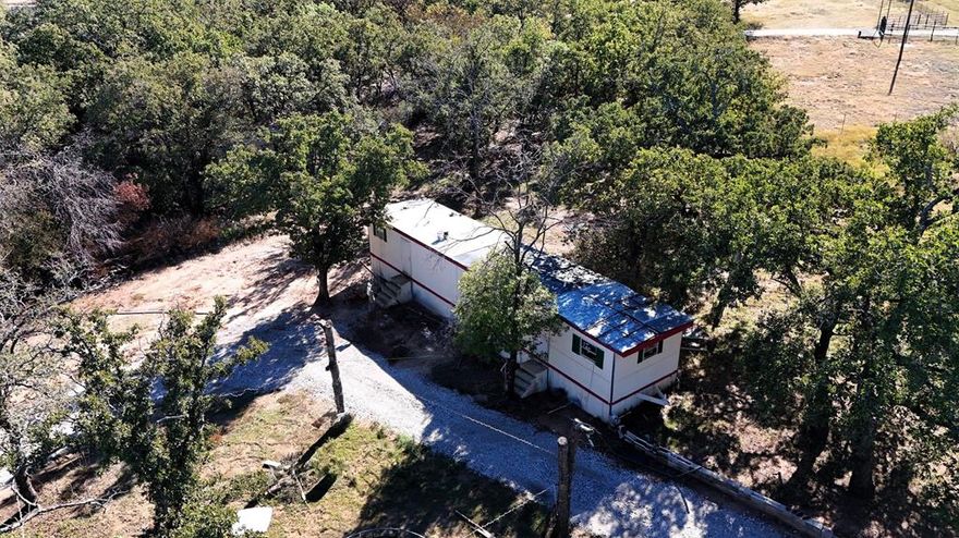Great location, out of the city with beautiful trees, fenced and ready to be made your own. Older mobile home could be remodeled or removed and a new dream home built. Beautiful properties being built in this rural subdivision. This is your opportunity to get 2 acres at a reasonable price. Check it out!