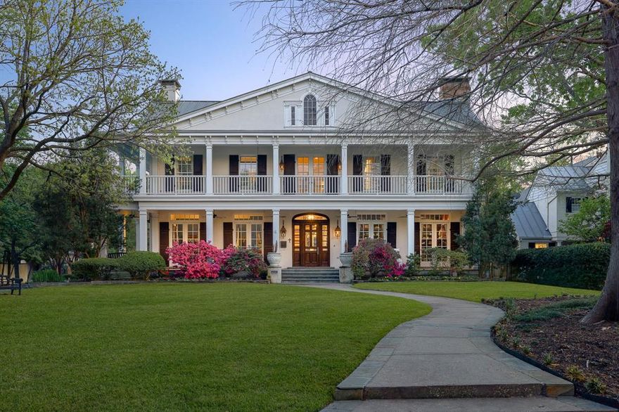 This stunning custom built estate, set on .46 acres in the coveted Volk Estates, is a rare opportunity to own a true legacy property in the best location University Park has to offer. Designed by renowned architect Richard Drummond Davis and built by Douglas Lueckemeyer in 1997, this timeless residence reflects the grace and elegance of classic Southern architecture. The home’s incredible curb appeal is defined by a symmetrical façade, grand double-height columns, expansive front porch with upper and lower galleries, and a gabled pediment—all hallmarks of the Southern Colonial Revival style. Accented with classic shutters, a central entry with sidelights and fanlight transom, and surrounded by flowering landscaping and manicured lawns, the home radiates hospitality and could easily grace the pages of Southern Living. Inside, the exceptional architectural details continue with soaring 11’ ceilings downstairs (10’ upstairs), wide-planked red oak flooring, and a layout built for both comfort and entertaining. The elegant floor plan offers spacious formal rooms, a large great room with built-ins and a wood-burning fireplace, and a gallery leading to a gracious backyard with room for a pool. The downstairs primary suite includes dual bathrooms and closets, with one closet featuring a secret door to the richly paneled library at the front of the home, with custom Mahogany paneling and a Gregor custom hand-carved mantle. Additional highlights include an oversized dining room, butler’s pantry, walk in pantry, wet bar, two offices, a cozy kitchen and breakfast area with knotty pine cabinetry and gas fireplace, plus a well-appointed laundry room. Upstairs, you'll find three generous bedroom suites, each with private bath, walk in closet and fireplace. The estate also includes a 3-car garage, abundant storage, updated HVAC systems, and recently replaced hot water heaters—all meticulously maintained. This is a generational legacy waiting for its next chapter in an A+ location.