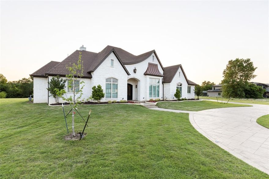 OPEN HOUSE SATURDAY, APRIL 30th, 11 am - 1 pm. Experience a rural oasis in the heart of the metroplex! This quintessential custom deigned 2-story, 4 bed, 3.5 bath, office and 3-car garage invites comfort & exudes elegance. Enjoy gathering w family in a gourmet kitchen awaiting your inner chef w granite, ample cabinets, gas cooktop, ss appliances, large master celebrating an ensuite w sep bath & shower, dual sinks, walk-in closet directly to utility room.  Spacious secondary w ensuite down, 2nd floor has 2 generous sized bedrooms with game room. Private patio w fireplace to enjoy picturesque wooded setting, quiet mornings & starlit nights. Near it all, great shops, bars & restaurants.